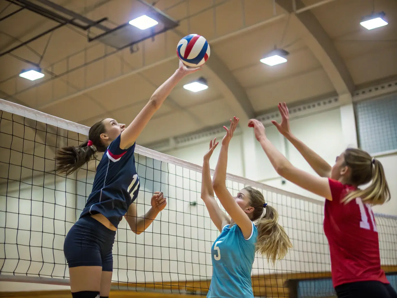 A diverse team of students collaborating during a volleyball match, demonstrating effective communication and strategic play.